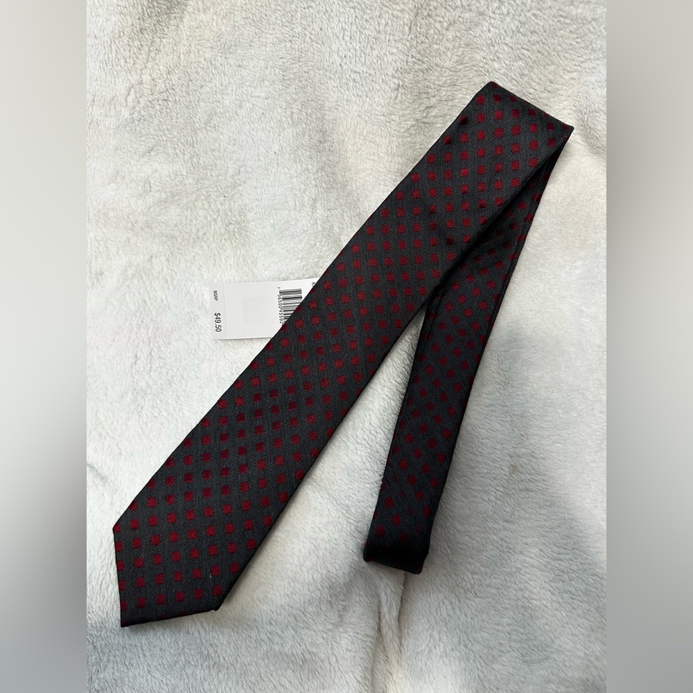 Calvin Klein men's necktie featuring a dark gray base with a red geometric squar
